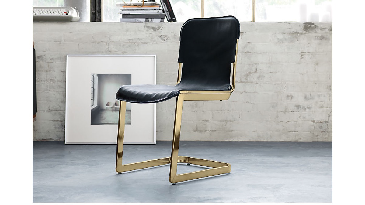 black armless chair with brass legs