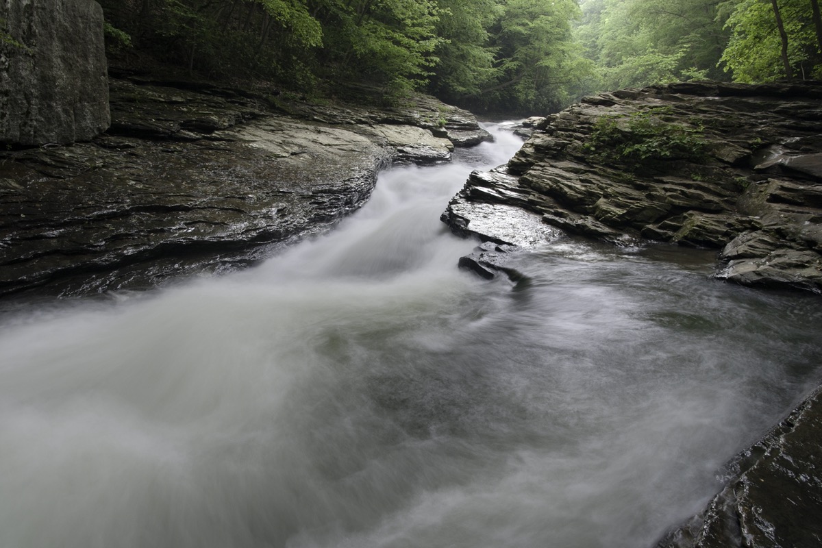 Meadow Run creek in Ohiopyle State Park, Pennsylvania. This section is a natural formed water slide that ends in a calm pool.
