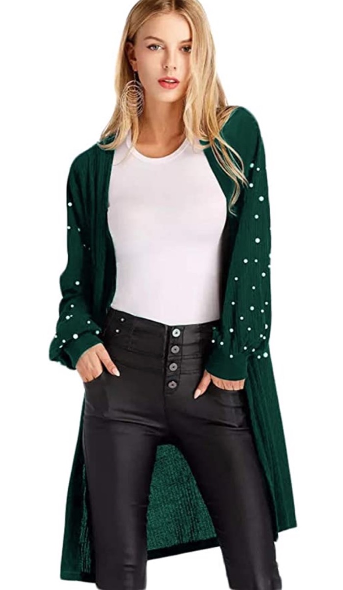 white woman in green cardigan with pearl embellished sleeves