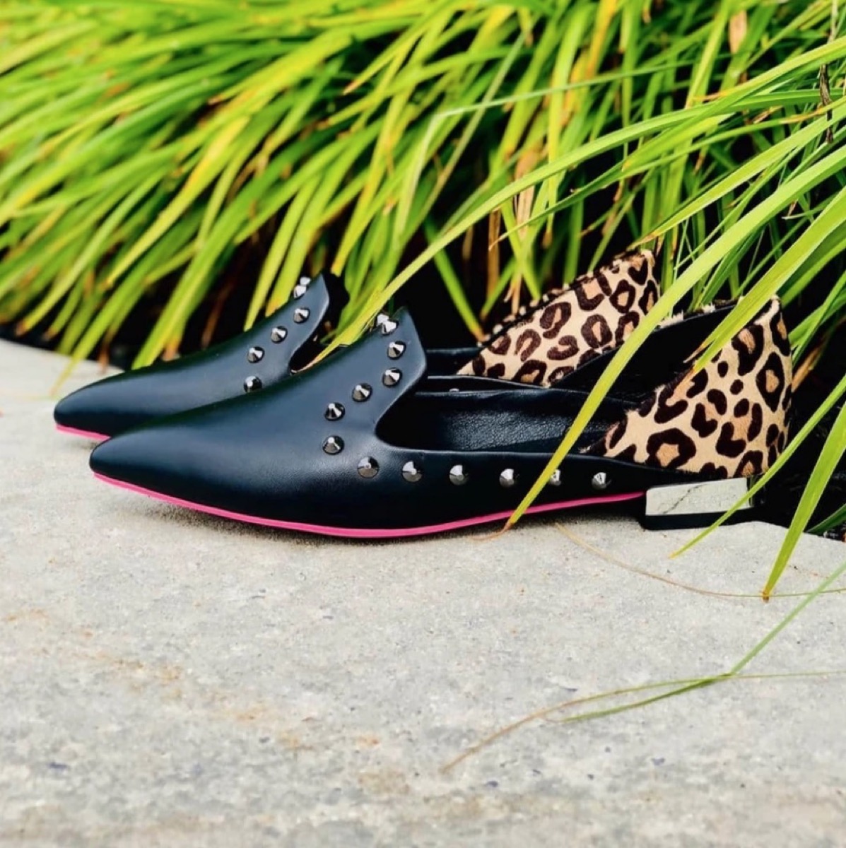 black leather flats with leopard backs and studs