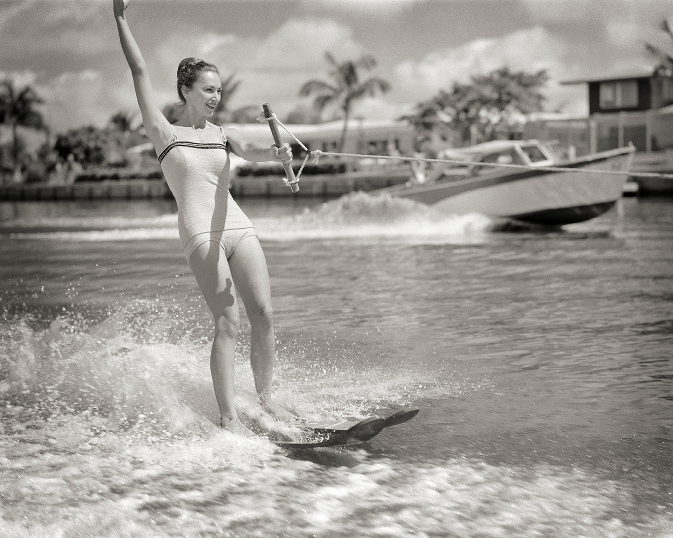 a woman water skis in the 1950s