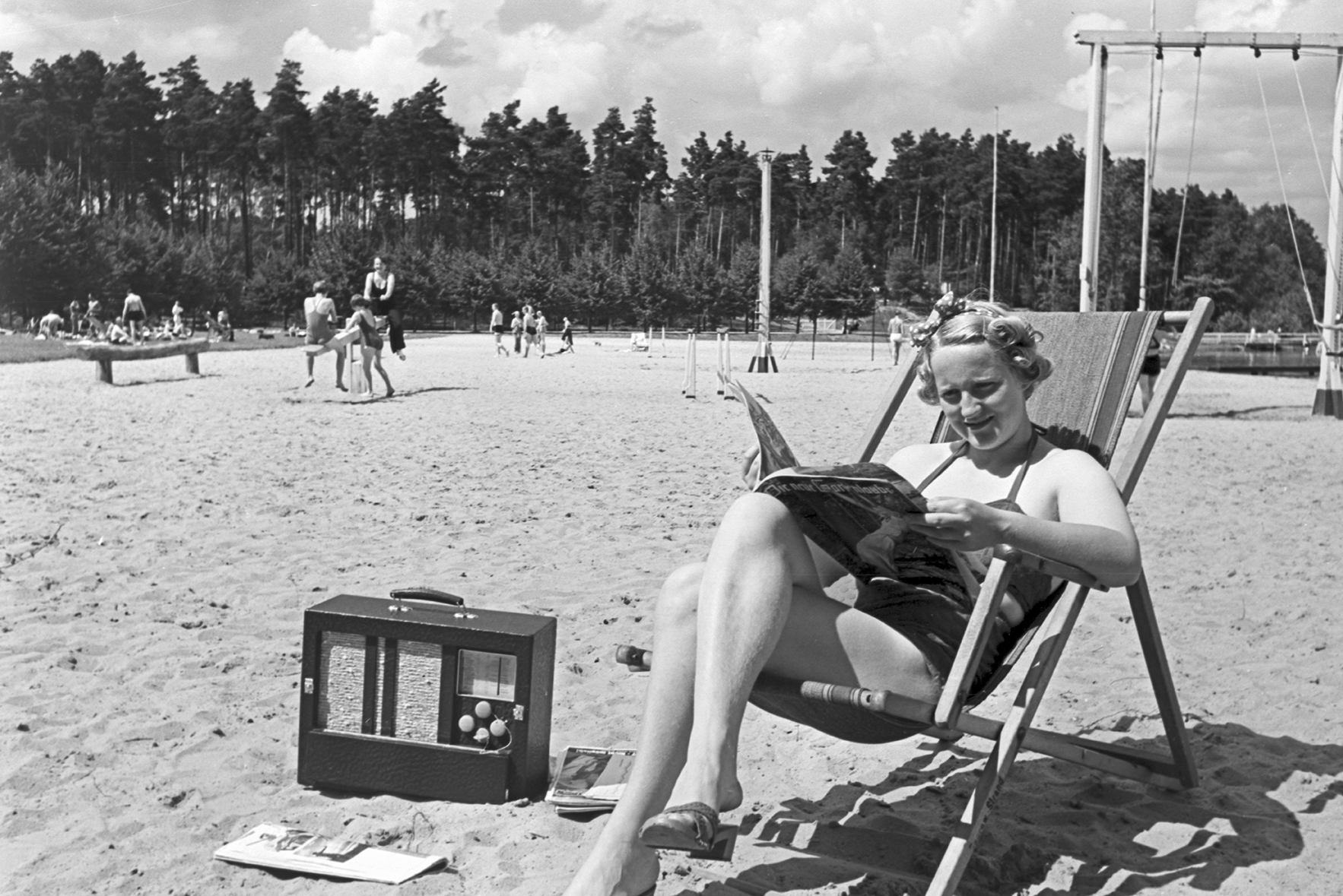 a woman reads a book on the beach