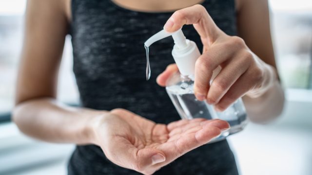 Woman using hand sanitizer