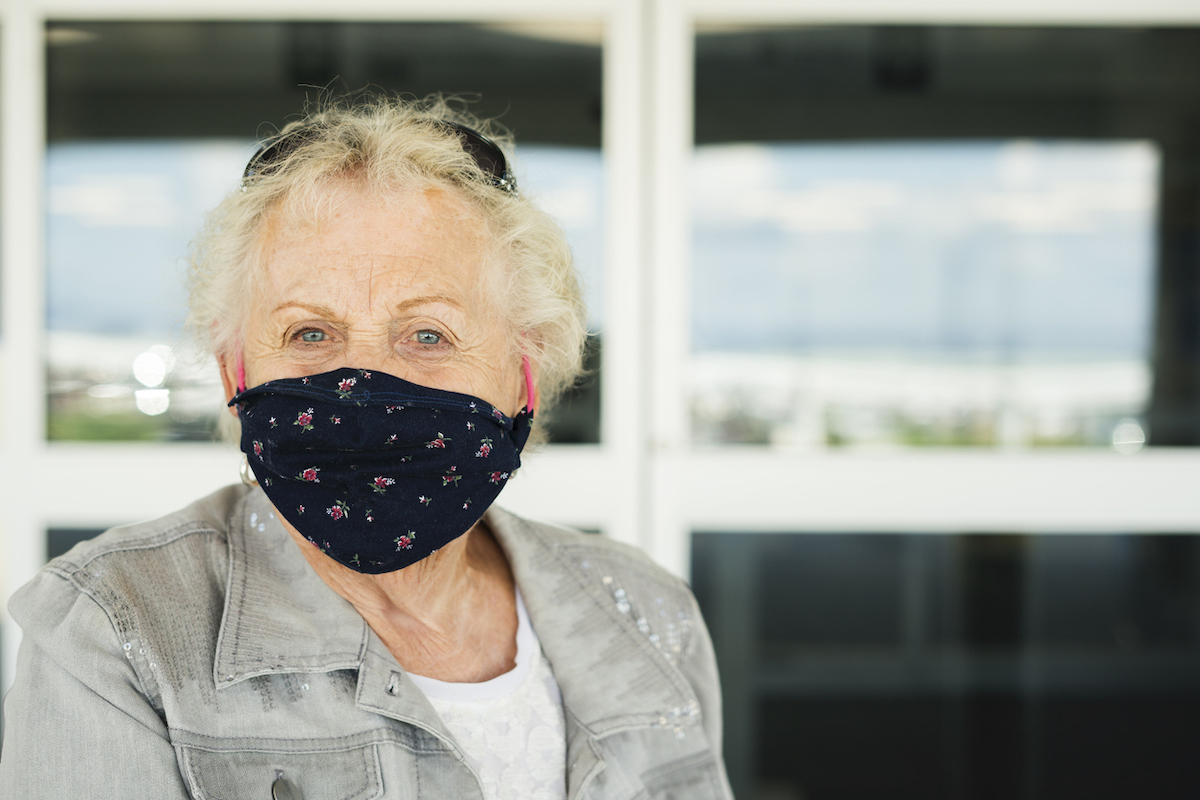 Senior woman wearing a face mask as required to enter an airport during Covid-19 pandemic, Indiana, USA