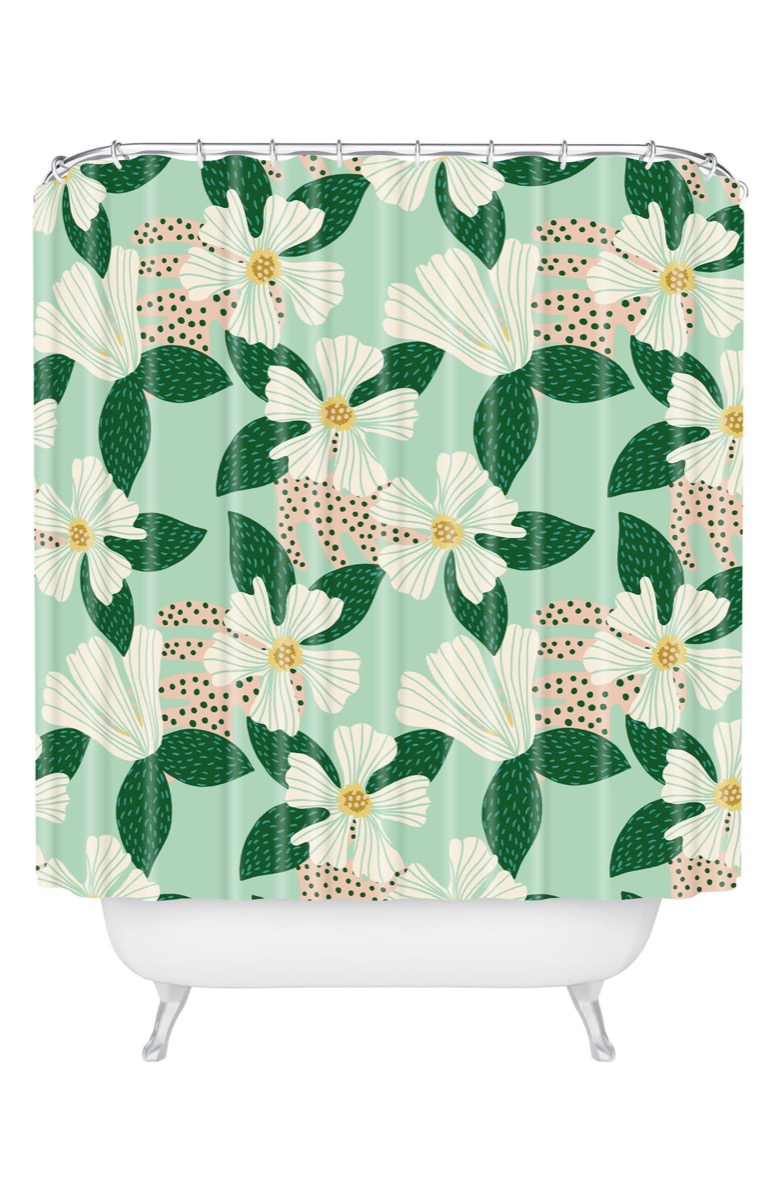 green shower curtain with white flowers