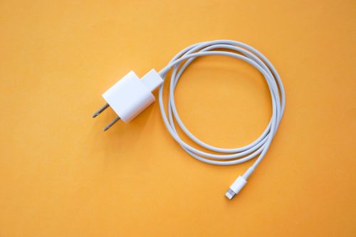 iphone charger on an orange background