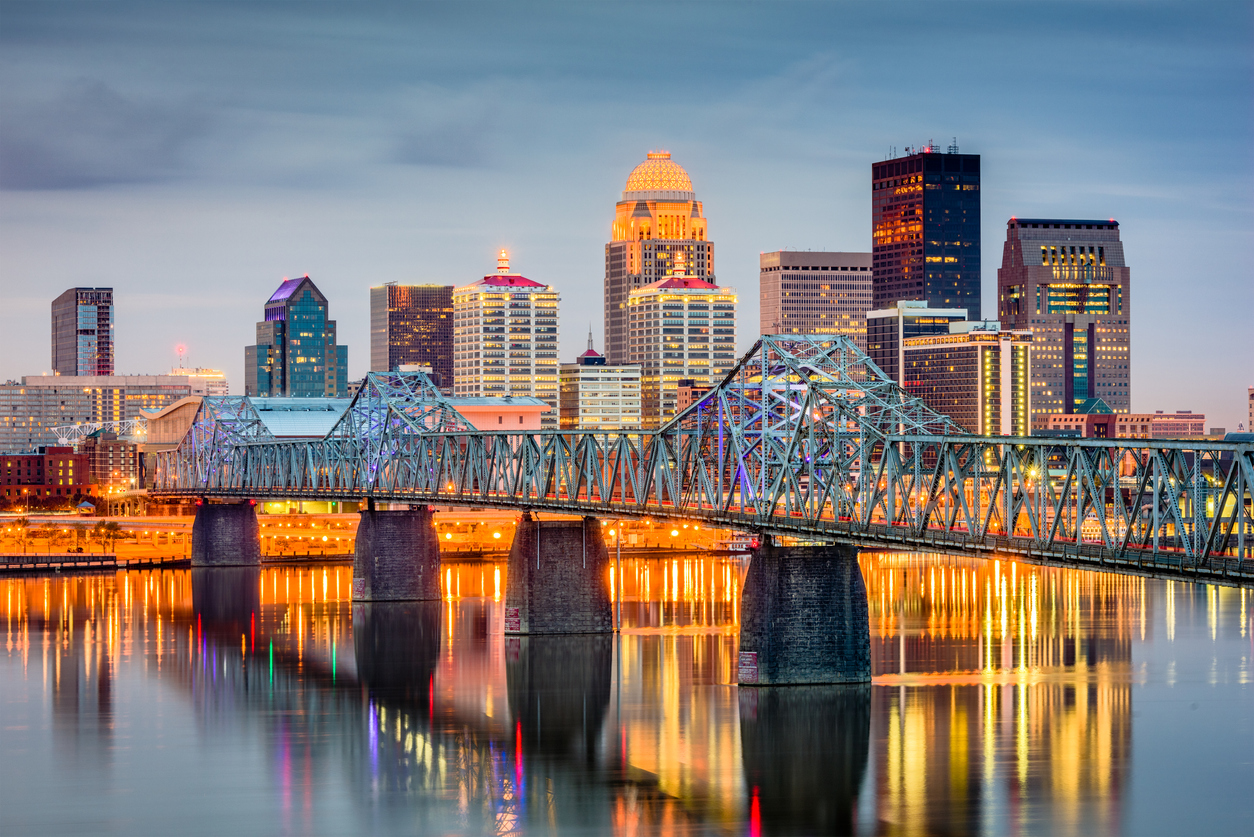 The skyline of Louisville, Kentucky with a blue bridge in the foreground