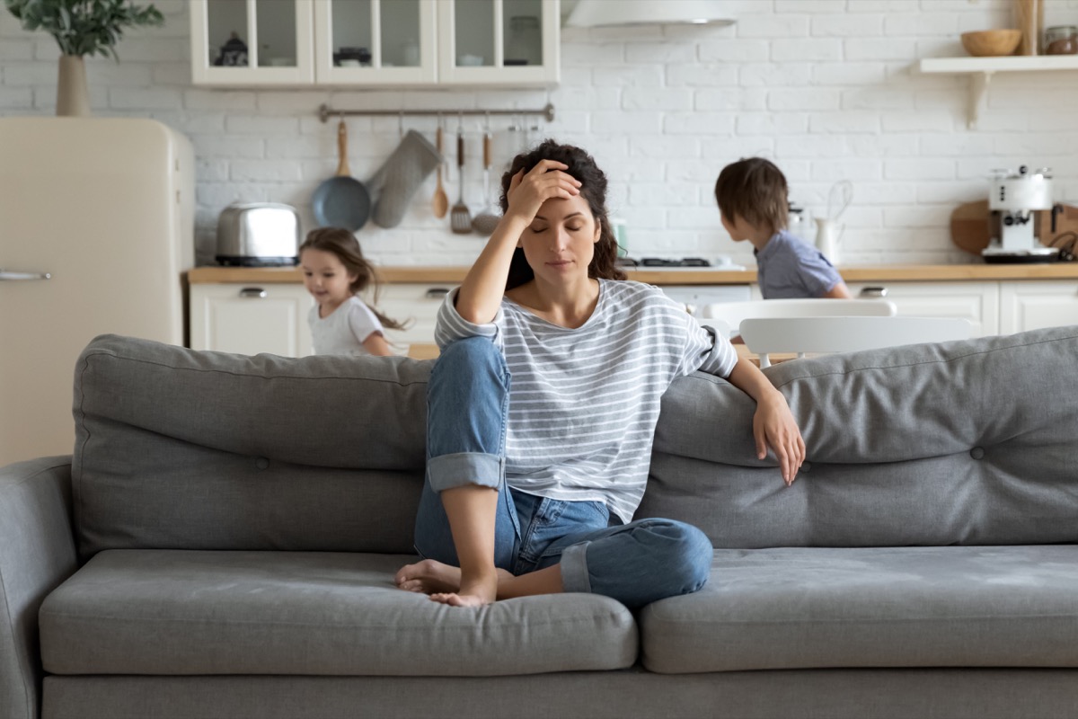 Woman with children experiencing anxiety and stress at home
