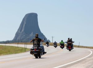 Bikers cruise along Highway 24 near Wyoming’s Devils Tower on Friday, August 14, 2020. Every year, bikers who attend the nearby Sturgis Motorcycle Rally in South Dakota descend on the iconic landmark.