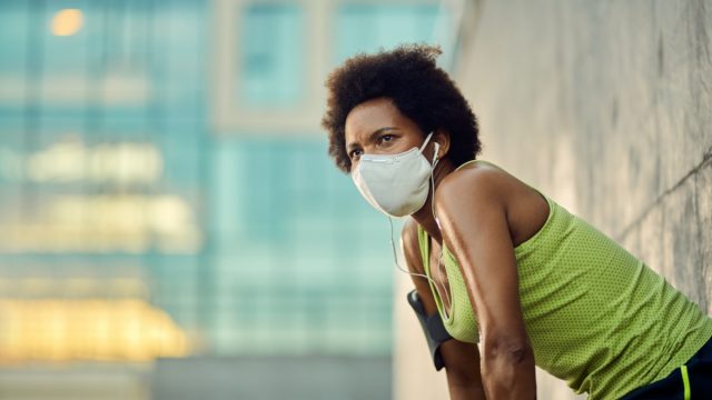 woman sweating wearing face mask after exercise