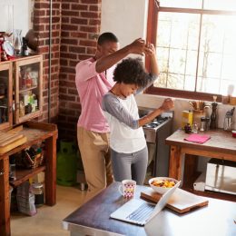 young black couple dancing in the kitchen