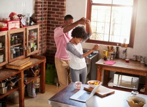 young black couple dancing in the kitchen