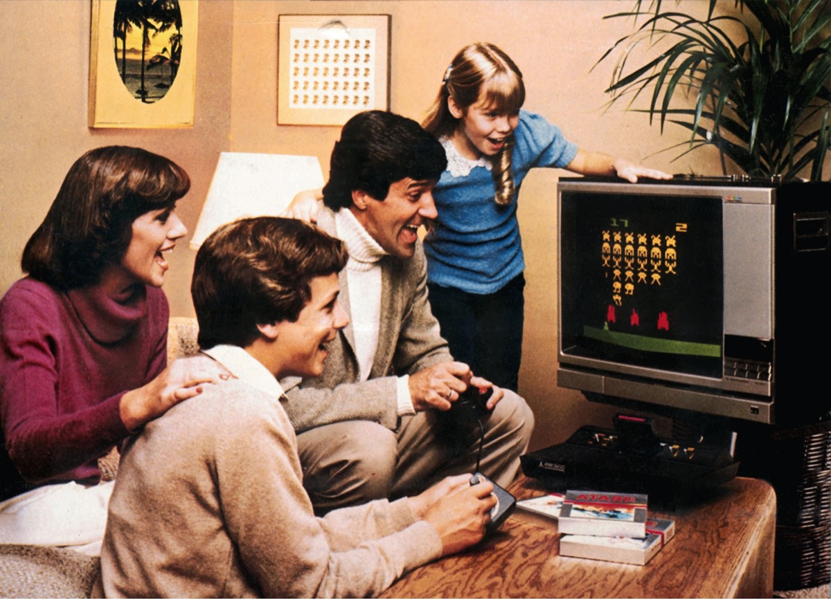 video games, Atari 2600 Video Computer System, early video game, family with paddle playing Space Invaders, 1978