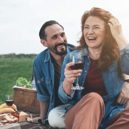 Middle-aged man and woman on picnic date