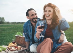 Middle-aged man and woman on picnic date