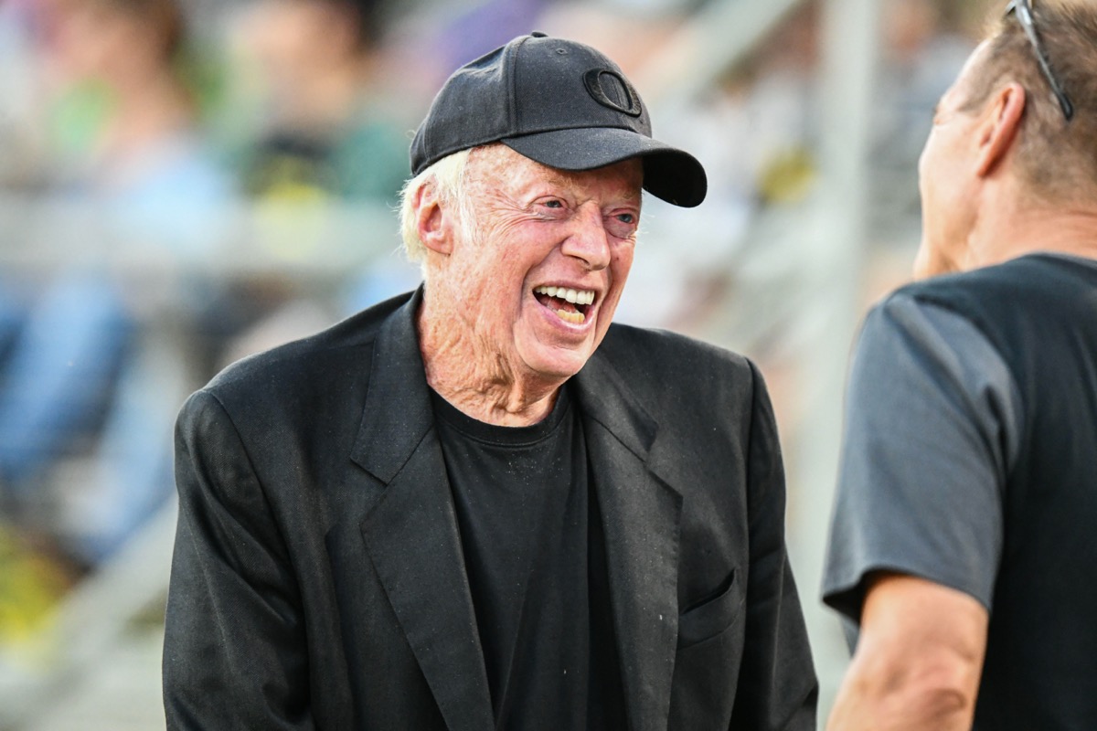 Nike co-founder Phil Knight is all smiles on the sideline during the NCAA football game between the Oregon Ducks and the Stanford Cardinal at Stanford Stadium