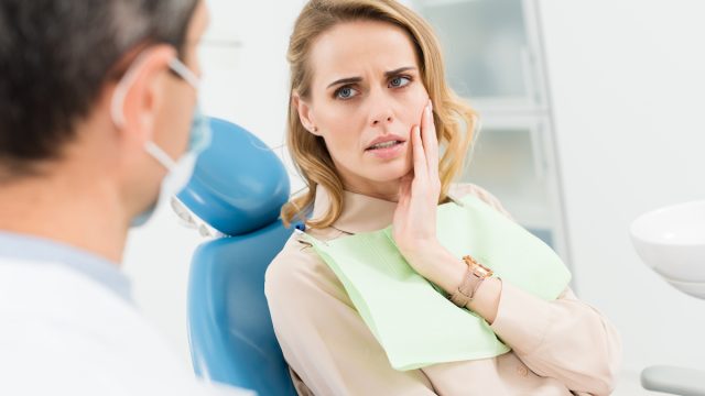 Woman at dentist with pain in her jaw