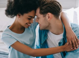 Young Black woman and young white man embracing