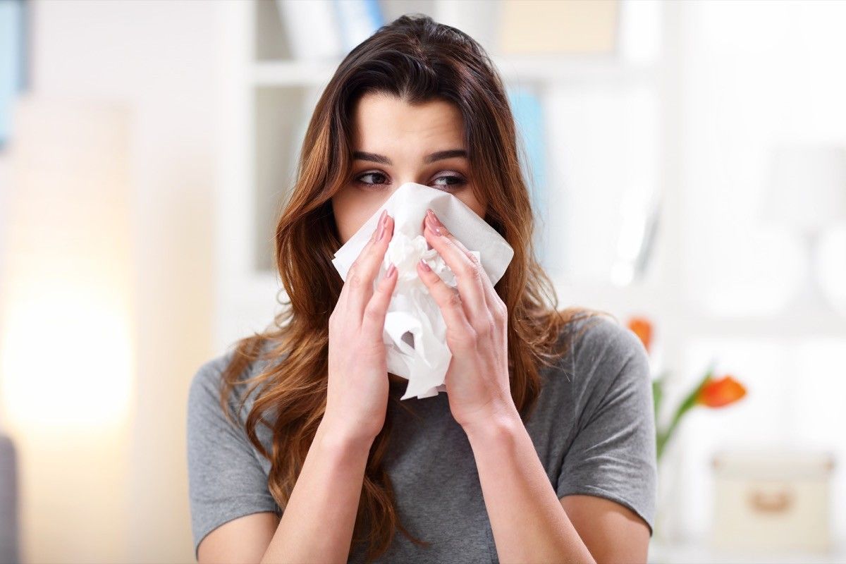 Woman sneezing from allergies