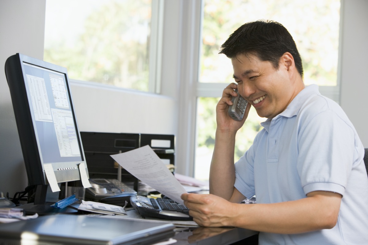 middle aged asian man looking at paperwork