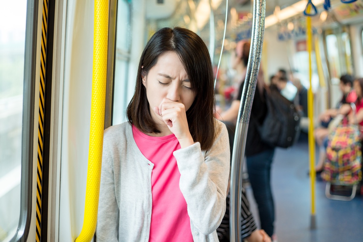 Woman coughing on the bus