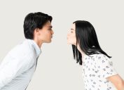 Side view of boyfriend and girlfriend puckering lips while preparing for kiss