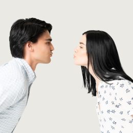 Side view of boyfriend and girlfriend puckering lips while preparing for kiss