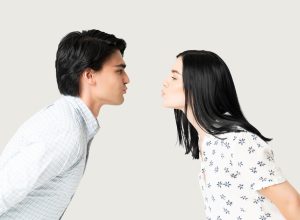 Side view of boyfriend and girlfriend puckering lips while preparing for kiss