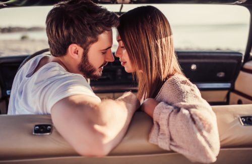 Couple about to kiss in the car