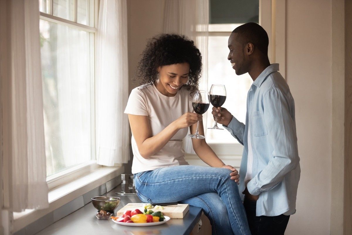 Couple drinking wine on a date laughing