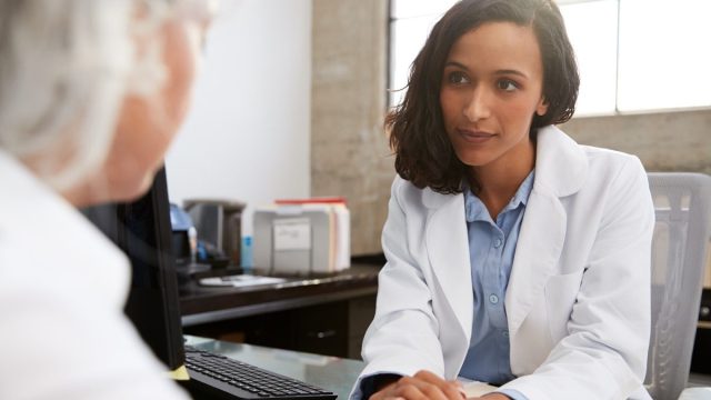 Doctor talking to woman with serious tone