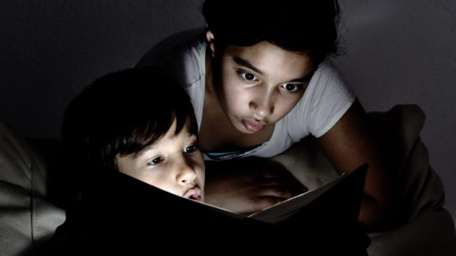 kids reading a ghost story