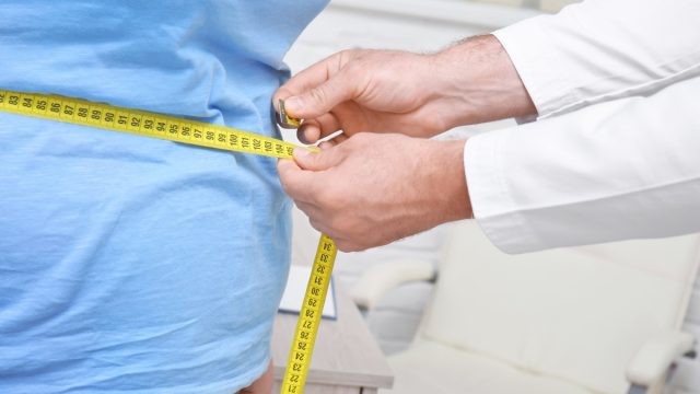 Person with obesity being measured