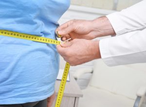 Person with obesity being measured