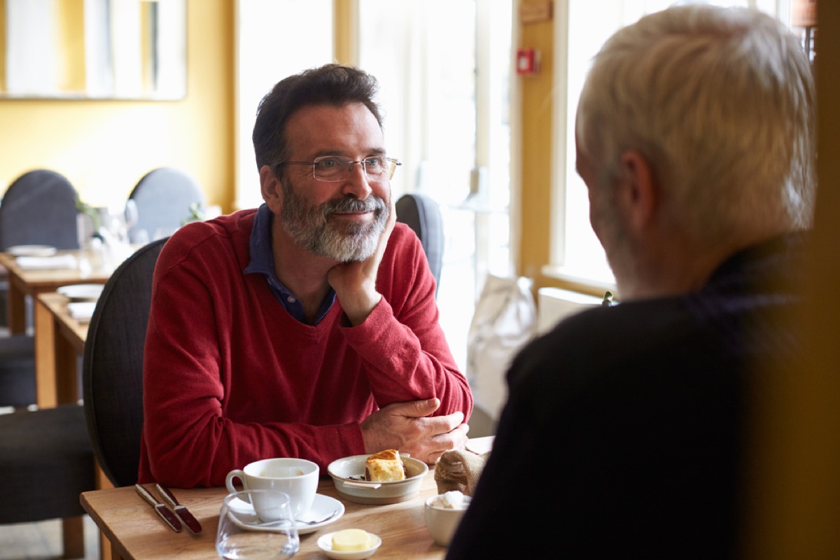 older gay white man having coffee across from other man