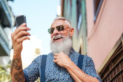 man with gray beard taking selfie