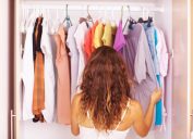 Rear view of a woman going through the clothes in her closet