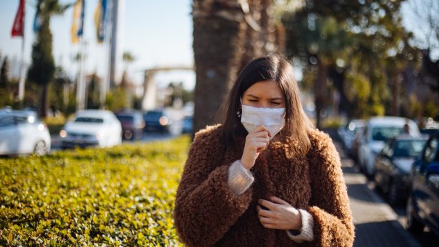 Young woman wearing mask to protect herself from virus