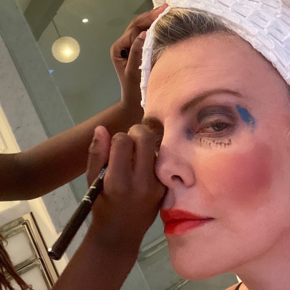 Charlize Theron having her makeup done by her daughter