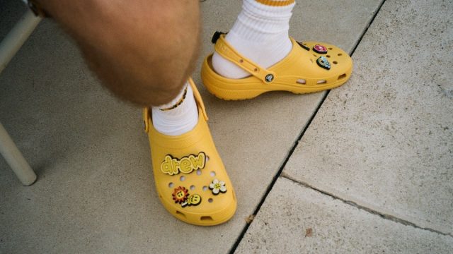 The Crocs X Justin Bieber with drew Classic Clog pulls inspiration from the signature yellow of Bieber’s personal clothing brand, drew house, and includes eight custom Jibbitz™ charms designed to match his good vibes and laid-back style.