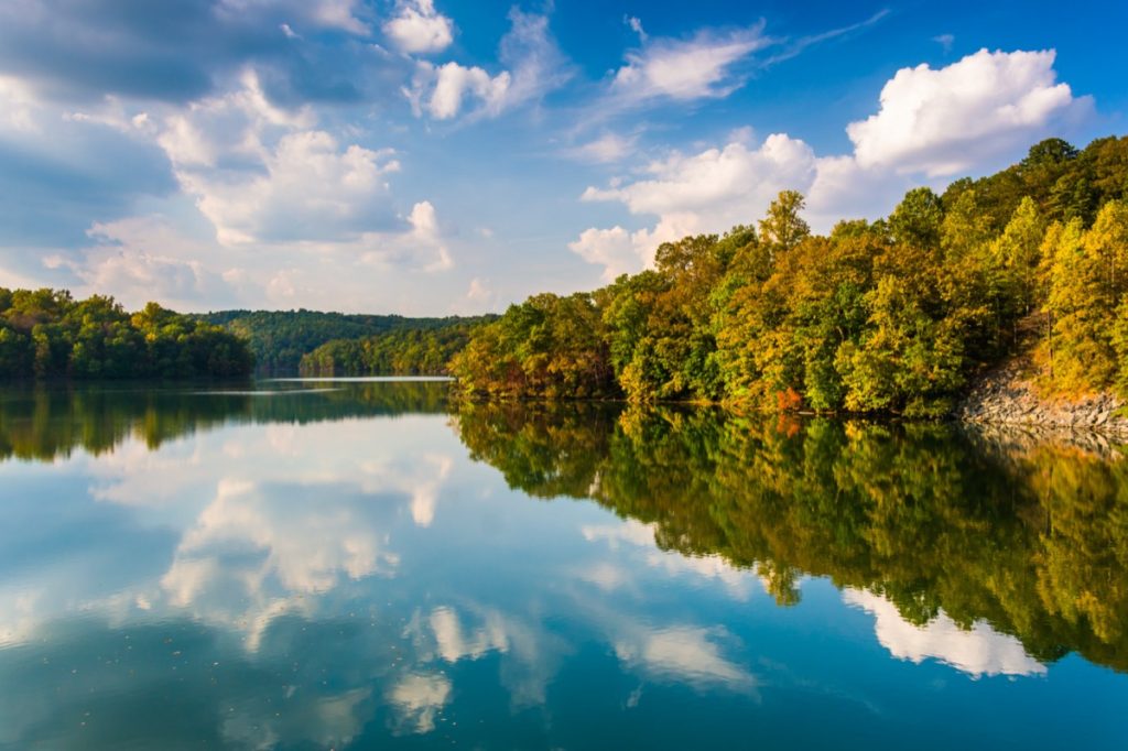 clouds and trees reflecting in the Prettyboy Reservoir in Baltimore County, Maryland