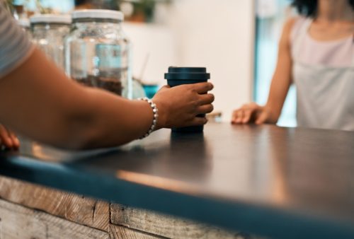 Cropped shot of a woman ordering a drink at a coffee shop