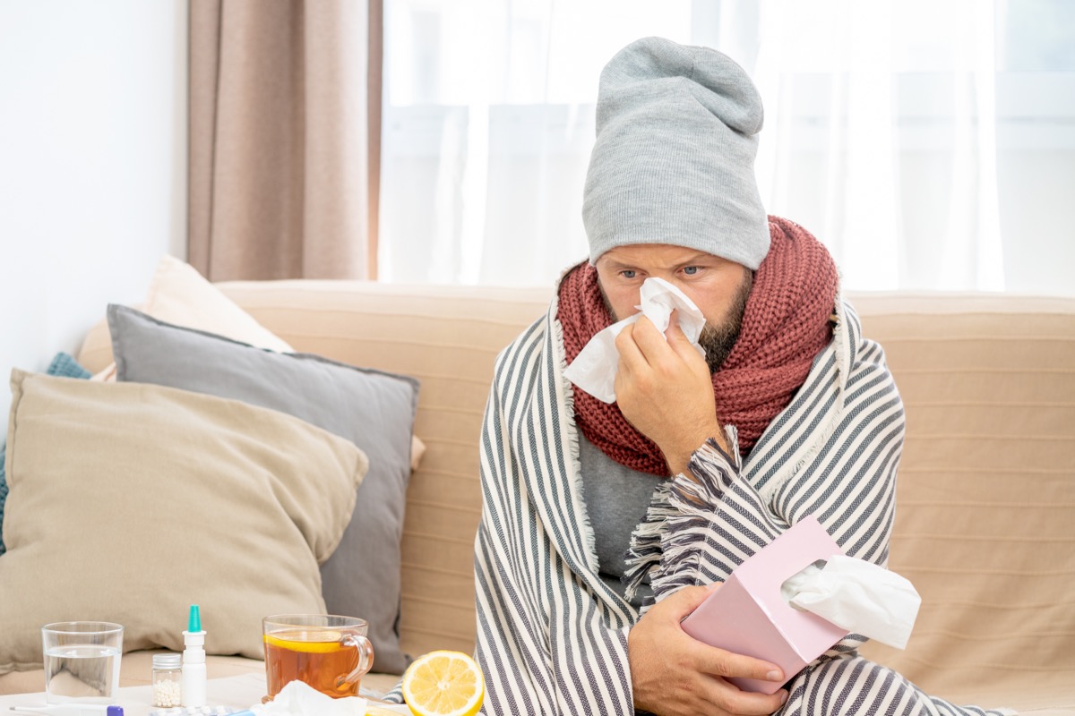 Man with a cold infection staying home sick
