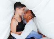 Couple flirting under the comforter