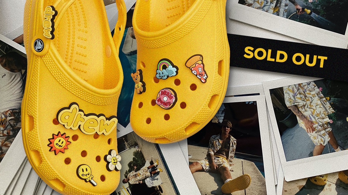 embellished yellow crocs next to a sign reading "sold out"