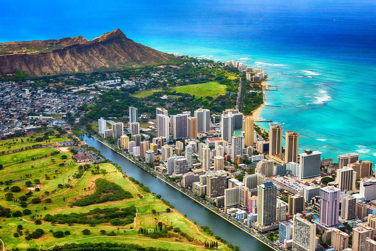 An aerial photo of Waikiki Beach and downtown Honolulu, Hawaii with Diamond Head in the background