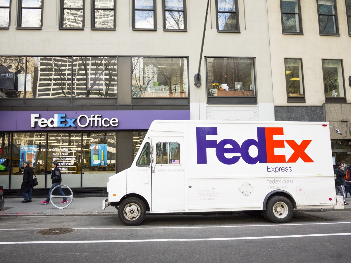 New York, New York, USA - March 13, 2013: A parked FedEx Express truck in midtown Manhattan in front of a Fedex Office store in the afternoon. FedEx is one of the leading package delivery services offering many different delivery options. Fedex Office stores act as a shipping depot as well as office supply and service stores. People can be seen on the street. [url=/my_lightbox_contents.php?lightboxID=3623142]Click here for more[/url] New York images and video.