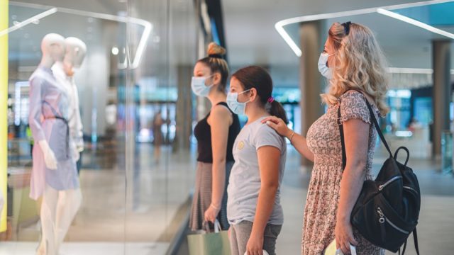 Family shopping at the mall during COVID-19 pandemic. They wears a protective mask to protect from coronavirus COVID-19.