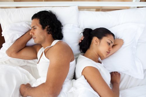 Couple in bed not having sex not talking