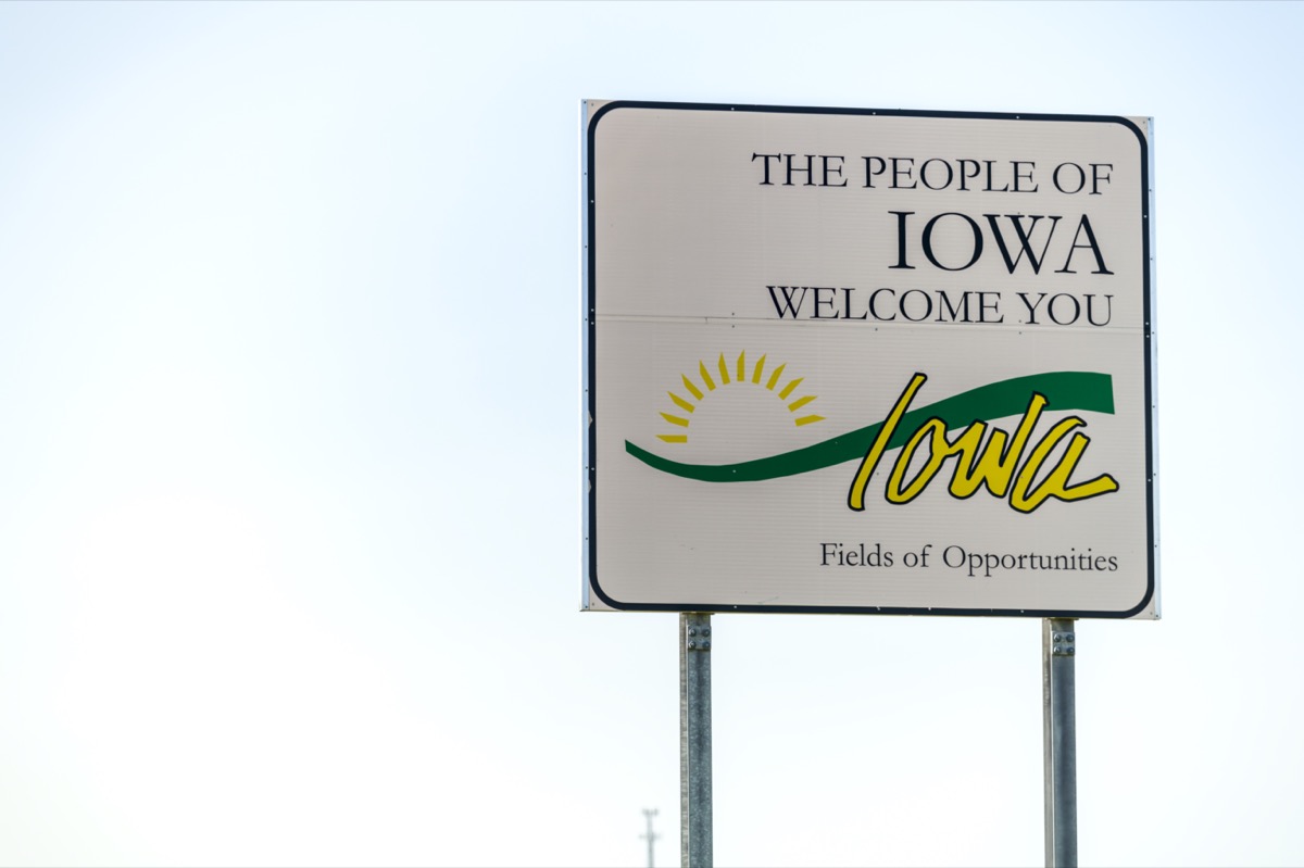 a white "The People of Iowa Welcome You" sign
